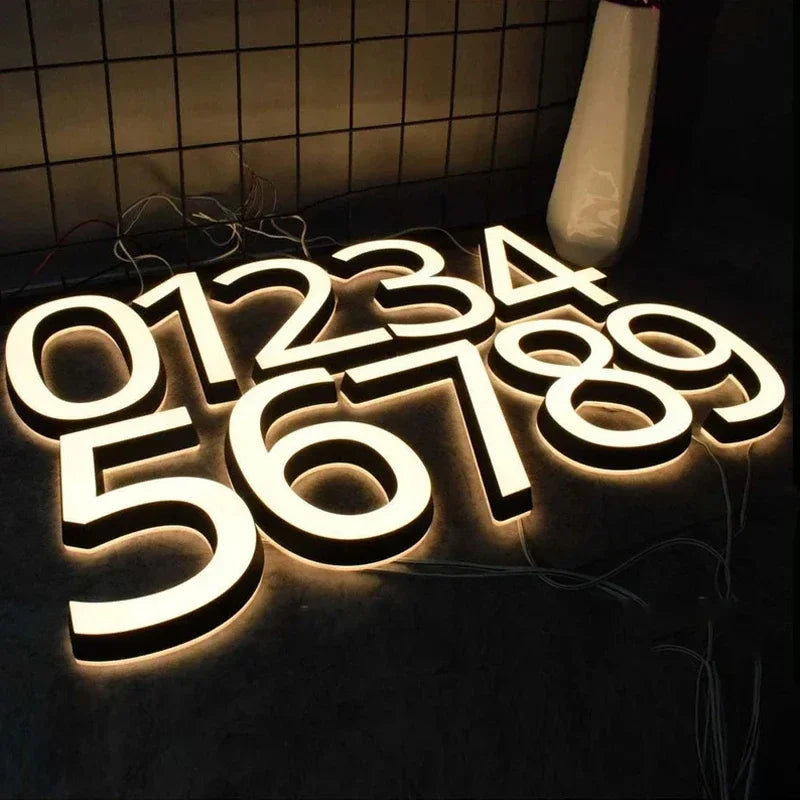 3D LED address numbers mounted on wall at night
